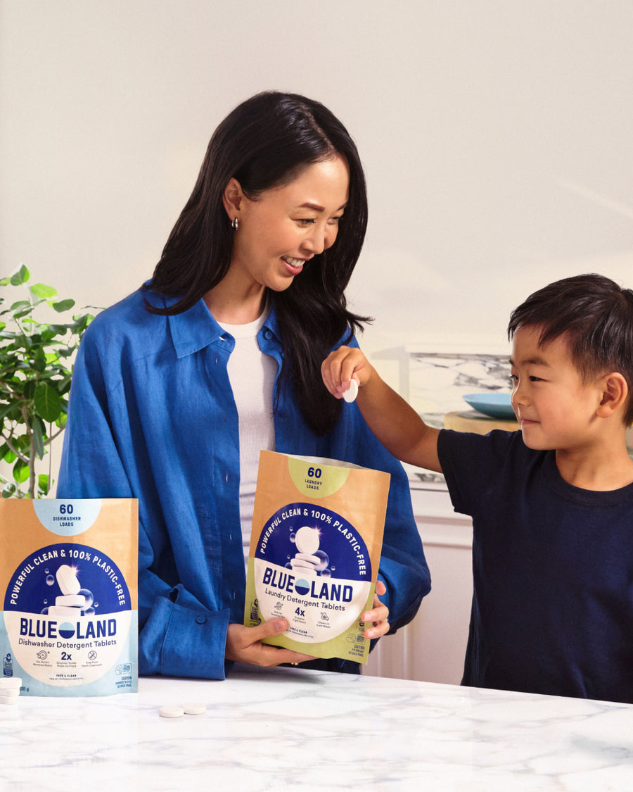 Blueland refillable cleaning bottles lined up on a kitchen counter