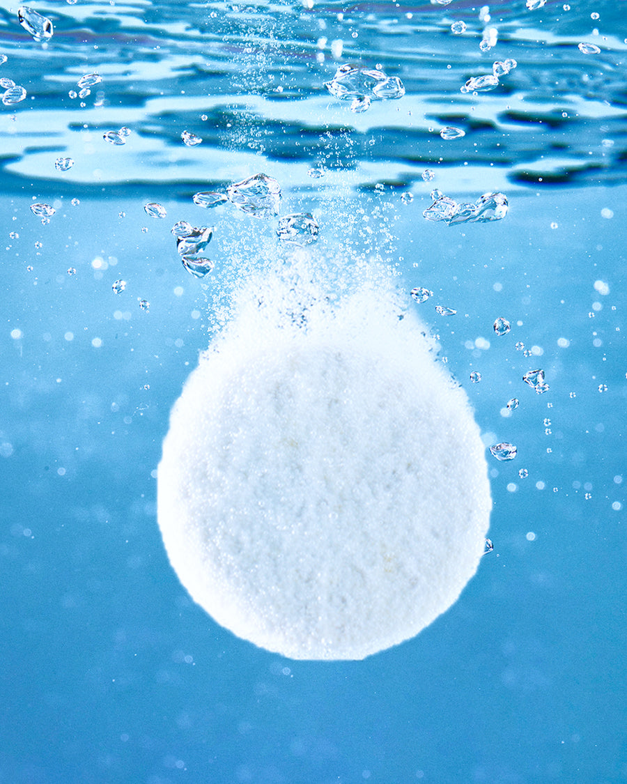 Blueland dishwasher tablets beside a clean plate